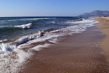 A wave on the shore of a sandy seashore. Patara Beach