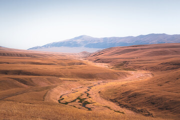 Sweeping vista landscape of the Assy Plateau, a large mountain steppe valley and summer pasture 100km from Almaty, Kazakhstan.