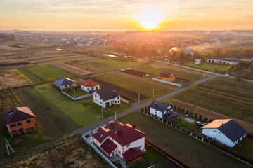 Aerial view of private homes in rural suburban area at sunset.