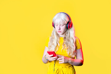 young blonde caucasian woman enjoying music using smartphone