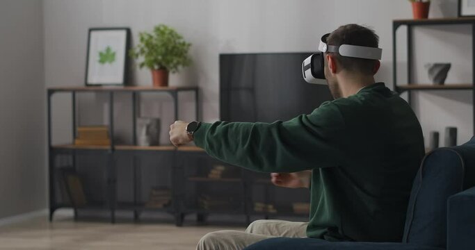 vr simulator of automobile riding, racing and driving car, adult man with hmd gadget is having fun in room, virtual reality