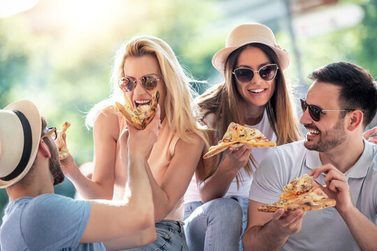 Group of friends eating pizza