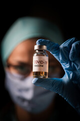 Female doctor holding a COVID-19 vaccine