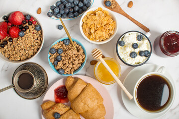 Huge healthy breakfast with coffee, fruits, muesli