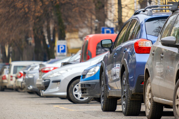Cars parked in a row on a city street side.