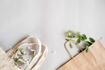 Zero waste shopping concept - cotton bag, craft paper bag, glass bottle for water