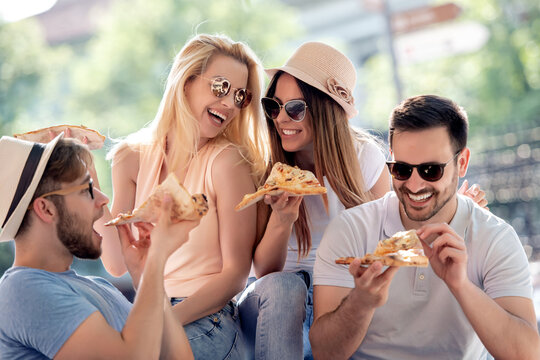 Group of friends eating pizza
