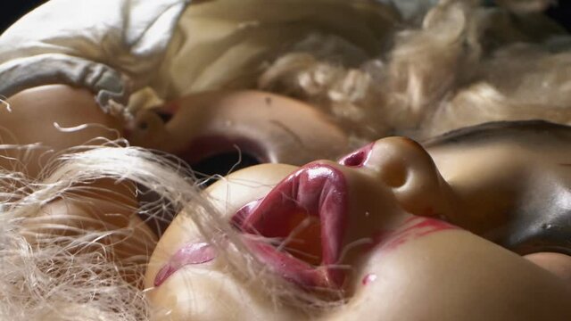 extremely close-up detailed. broken mutilated dolls. halloween concept.