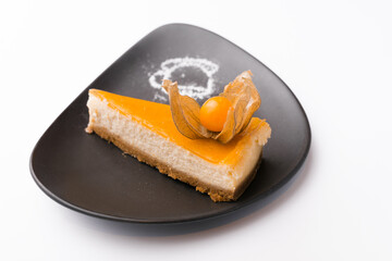Beautiful and tasty cheesecake of pumpkin over white background.