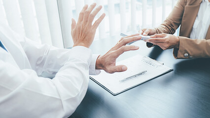 Businessman refusing money in the envelope to agreement contract, Bribe and corruption concept