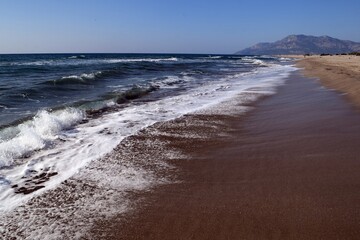 Fototapeta na wymiar A wave on the shore of a sandy seashore. Patara Beach