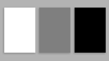 Fototapeta na wymiar Three blank sheets on a gray background. White, gray, black.