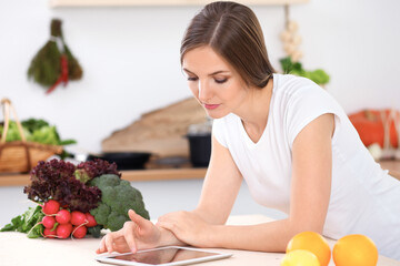 Young woman is making online shopping by tablet computer and credit card