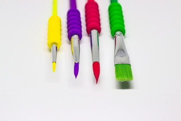 Colorful paint brushes on a white background