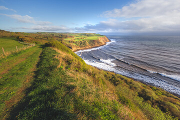 North Yorkshire coastline landscape and seascape with dramatic cliffs along Cleveland Way from Burniston to Hayburn Wyke in North York Moors National Park, England.