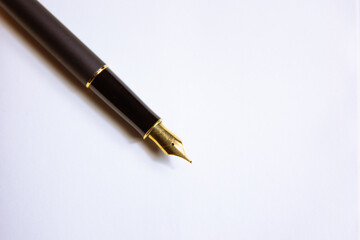 Close-up of a fountain pen on a notebook. Concept of writing poetry. International Poetry Day