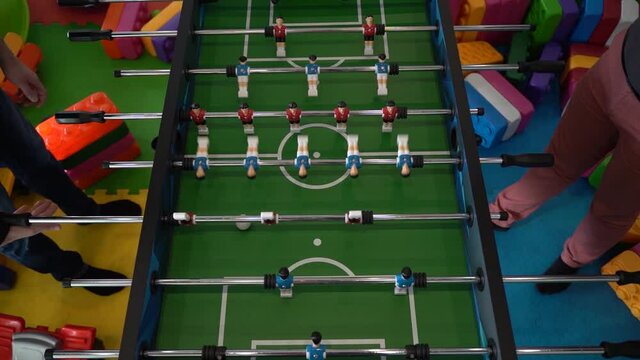 Foosball. Hands of a man playing table football