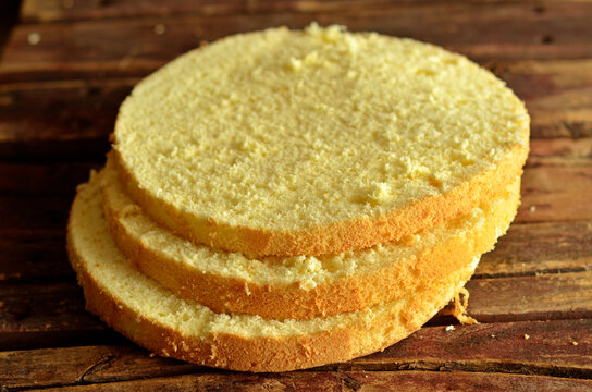 Gluten-free sponge cake cut into rings on a wooden background