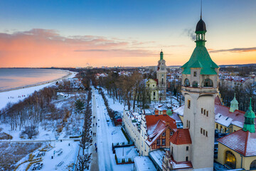 Beautiful sunset over the snowy beach and pier (Molo) in Sopot at winter. Poland