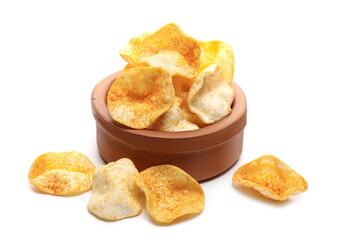 Potato chips with paprika flavor in clay bowl, pepper powder crisps isolated on white background