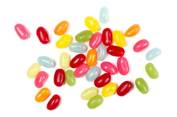 Sour jellybeans, colorful fruit candy dessert snack pile isolated on white background, top view