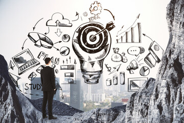 Plan to achieve the goal concept with businessman in the mountain and drawn sketch of business ideas. Double exposure.