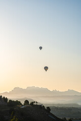 Amanecer paisaje globos volando sobre montañas 