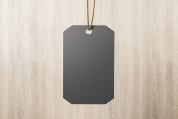 Modern blank dark grey paper label tag at abstract wooden background. Eco friendly label tag...