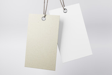Blank grey hanging tag made from recycled eco-friendly paper with cotton twine at light abstract background. Mock up. Eco label tag concept. 3D rendering