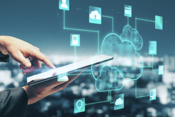 Online storage concept with man touching digital tablet and digital screen with social application icons at blurry city background