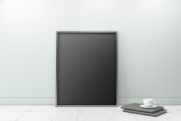 Black blank poster in black frame on marble floor near black books with cup of coffee leaning on modern wall. Mockup. 3D rendering