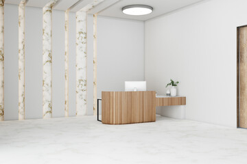 Spacious hotel hall with reception table and computer.
