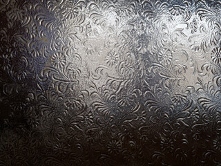 Dark glass texture with patterns, glass texture behind which there is light