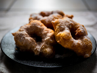 Woman frying vegan cattas sweet fritters, Sardinian Carnival cakes