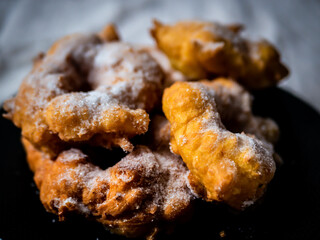 Woman frying vegan cattas sweet fritters, Sardinian Carnival cakes