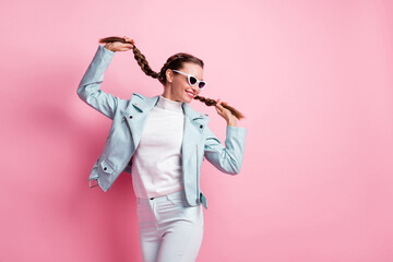 Photo of young cheerful girl happy positive smile childish playful look empty space isolated over pastel color background