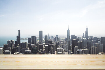 Empty wooden table top with beautiful Chicago skyscrapers at daytime on background, mock up