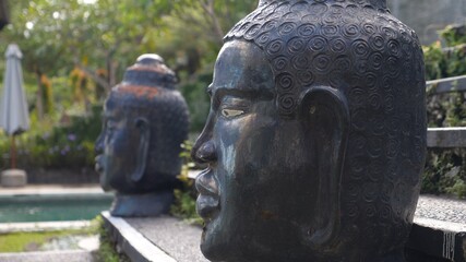 Fototapeta na wymiar Giant Buddha heads next to the swimming pool.Close up 
