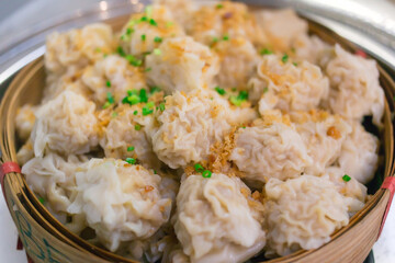 Shaomai is a Chinese food which it made from pork on top with fried garlic and chopped spring onion put on bamboo basket.