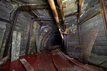Dark creepy flooded abandoned mine tunnel