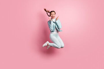 Fototapeta na wymiar Full length photo portrait of amazed woman jumping up isolated on pastel pink colored background