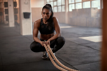 Fit woman tired after a rope workout
