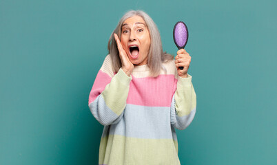 gray hair pretty woman with a hair brush