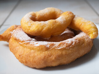 Closeup of plate with vegan cattas sweet fritters, Sardinian Carnival cakes