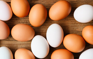 Fresh Chicken eggs and duck eggs on wooden background top view, collect from farm products natural in a sack healthy eating concept.