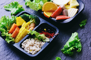 Plastic box food with healthy food box fruit vegetable salad sauce service food order online delivery, Food delivery in take away boxes package on wooden table at home.