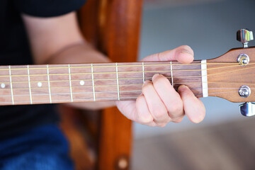 Home hobbies concept, Man hands playing acoustic guitar, close up guitar player Musical instrument...