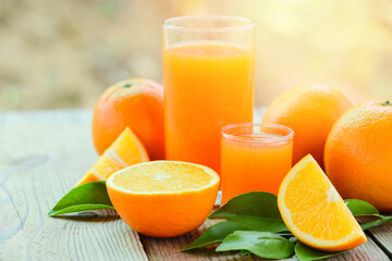 Fresh orange juice in the glass with orange fruit on wooden background, healthy fruits and orange slice.