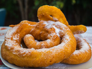 Closeup of plate with vegan cattas sweet fritters, Sardinian Carnival cakes