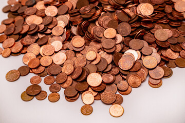 Many small euro coins on each other on white background
